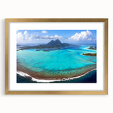 Extra large abstract art print of French Polynesia scenery in blue and green tones on a gold-framed canvas.