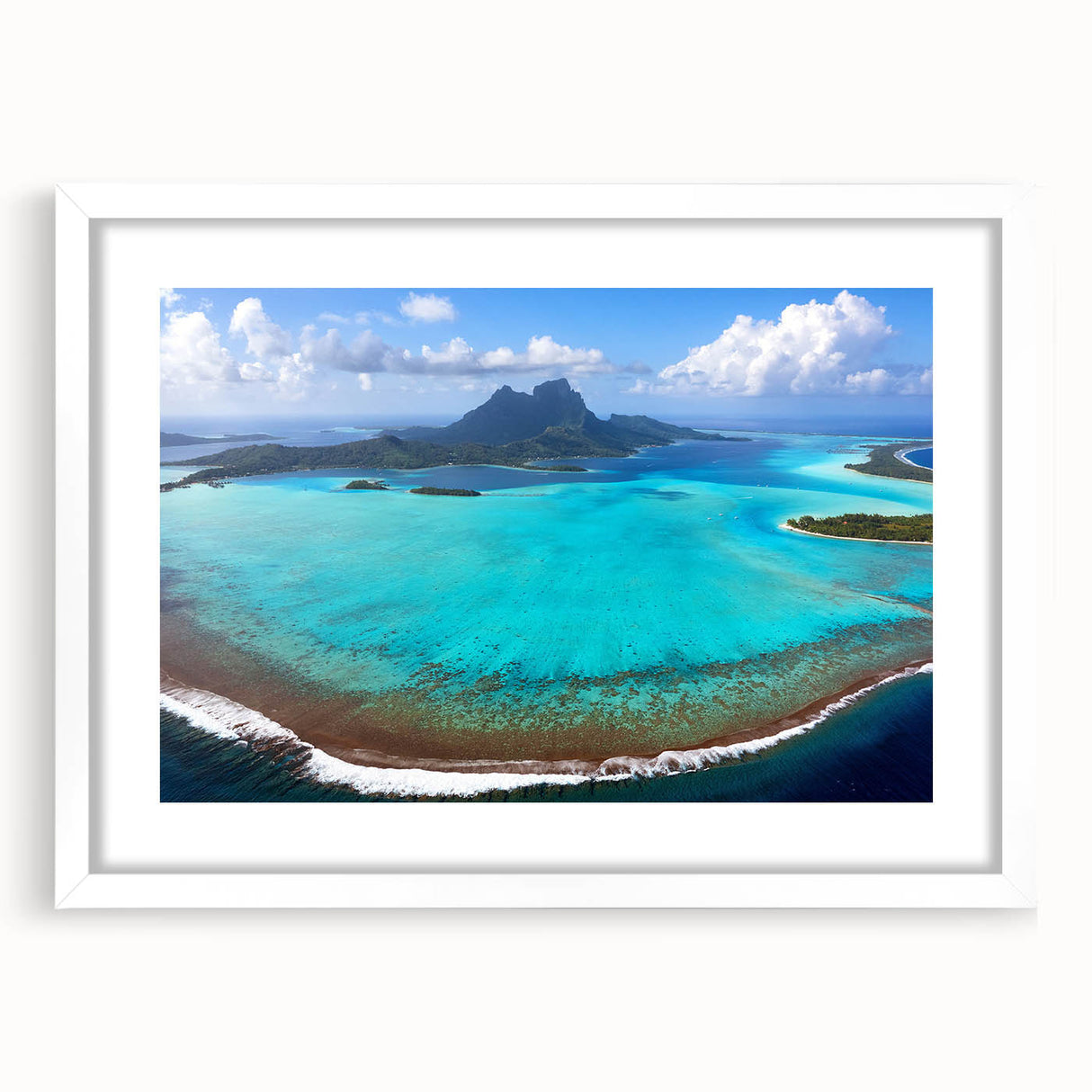 Abstract art print of Bora Bora landscape in soft blue and green tones on a white framed canvas.