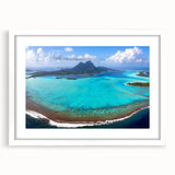 Abstract art print of Bora Bora landscape in soft blue and green tones on a white framed canvas.