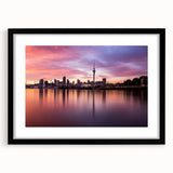 Extra large abstract art print of Auckland's skyline in vibrant, colorful hues on a black framed canvas.