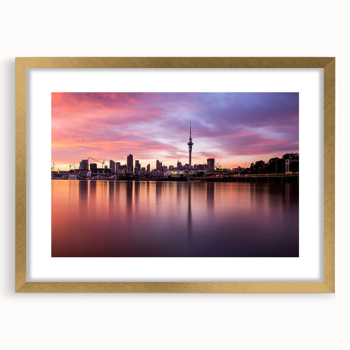 Extra large wall art featuring an abstract depiction of the Auckland skyline in textured gold and blue tones on a framed…