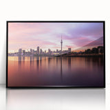 Large abstract wall art depicting the Auckland skyline in muted gray and blue tones, framed in black acrylic.