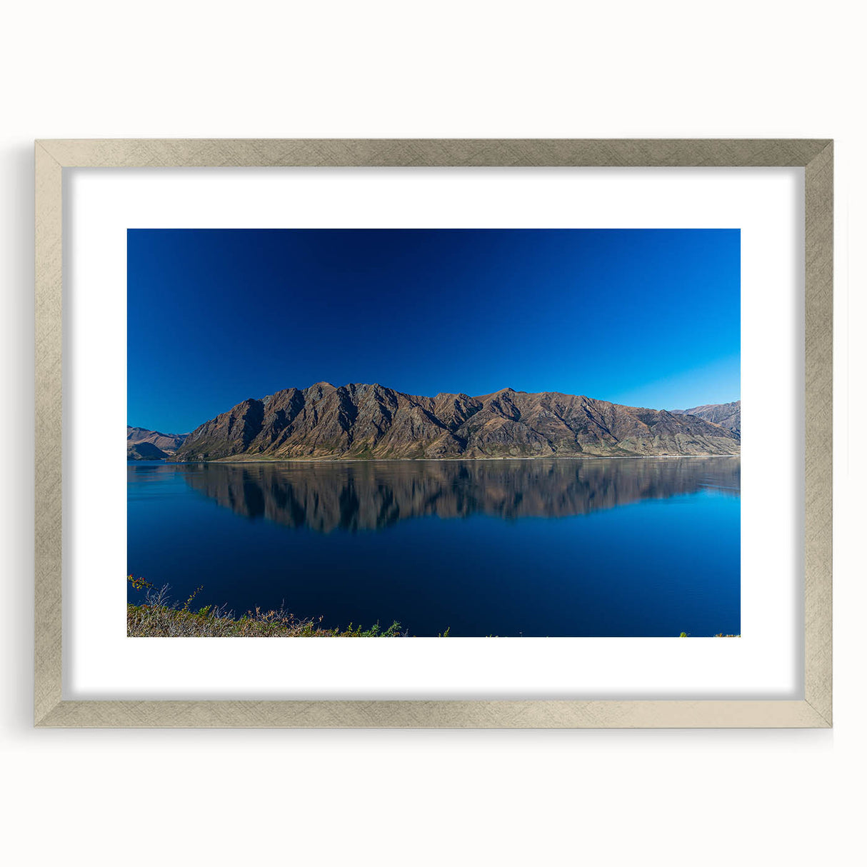 Textured art of abstract Otago, New Zealand scenery in silver frame, with muted earth tones, ideal for bedroom art.
