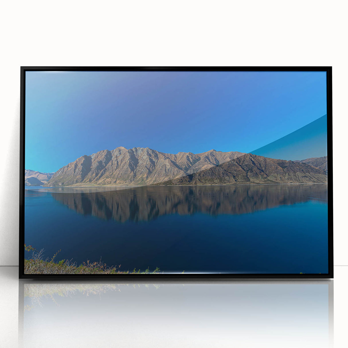 Large abstract wall art depicting the Otago, New Zealand scenery in muted earth tones, framed in black acrylic.