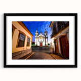 Colorful abstract art print of a textured South American scenery in a large black frame, suitable for living room decor.