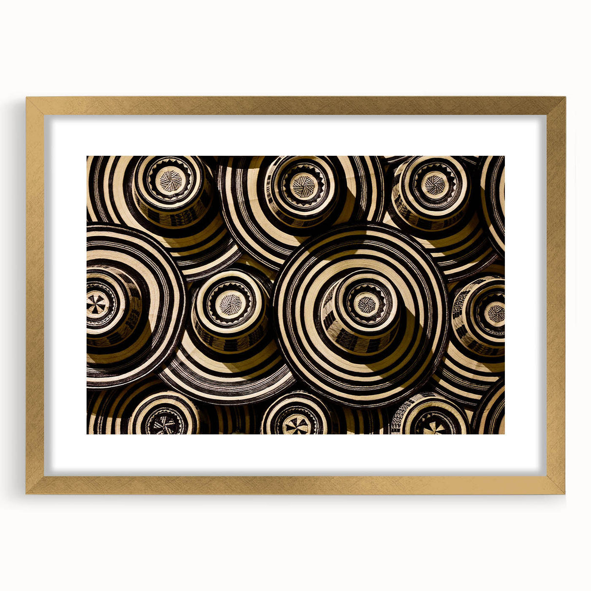 Extra large abstract art print of a textured Colombian landscape in vibrant earth tones, framed in gold.