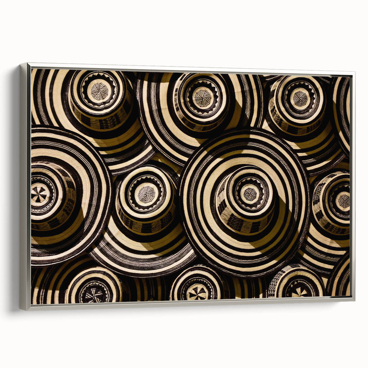 Framed canvas landscape art painting depicting a colorful Colombian village scene with black borders.