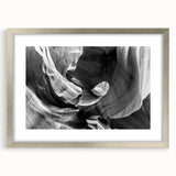 Textured art print of Arizona's Antelope Canyon in muted earth tones, framed in silver, suitable for bedroom decor.