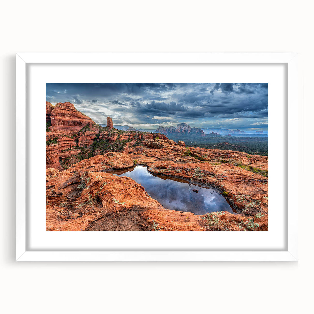 Abstract art print of Sedona landscape in muted red and orange tones on a white framed canvas, ideal for dining room decor.
