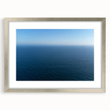 Textured abstract art print of Santa Monica in muted blue and gray tones on a framed canvas, ideal for bedroom art.