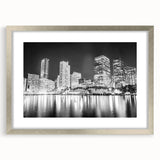 Textured art print of abstract Miami skyline in shades of blue and gray on a framed silver mat, suitable for bedroom decor.