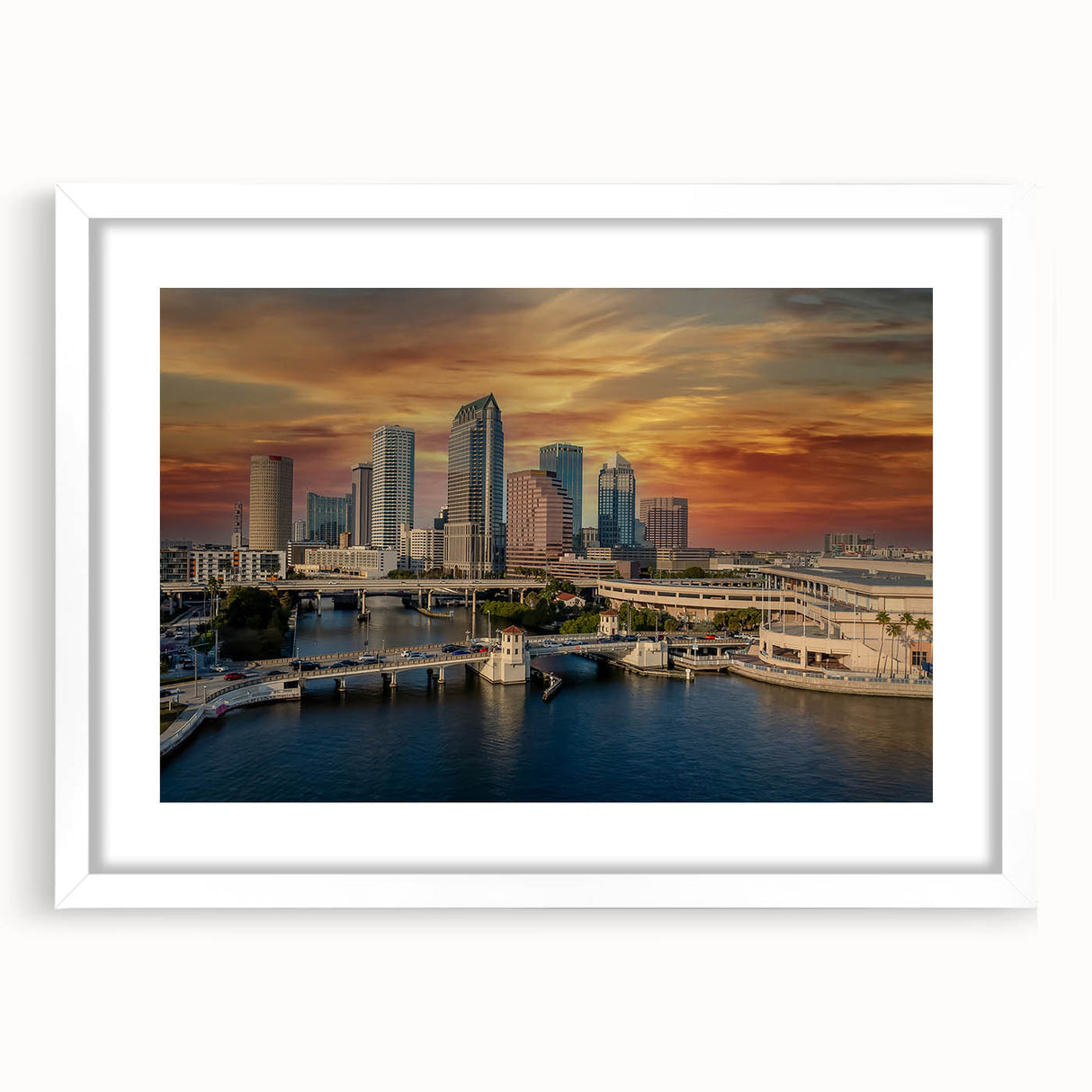 Abstract art print of Tampa skyline in muted blue and gray, framed with a white mat, suitable for dining room decor.
