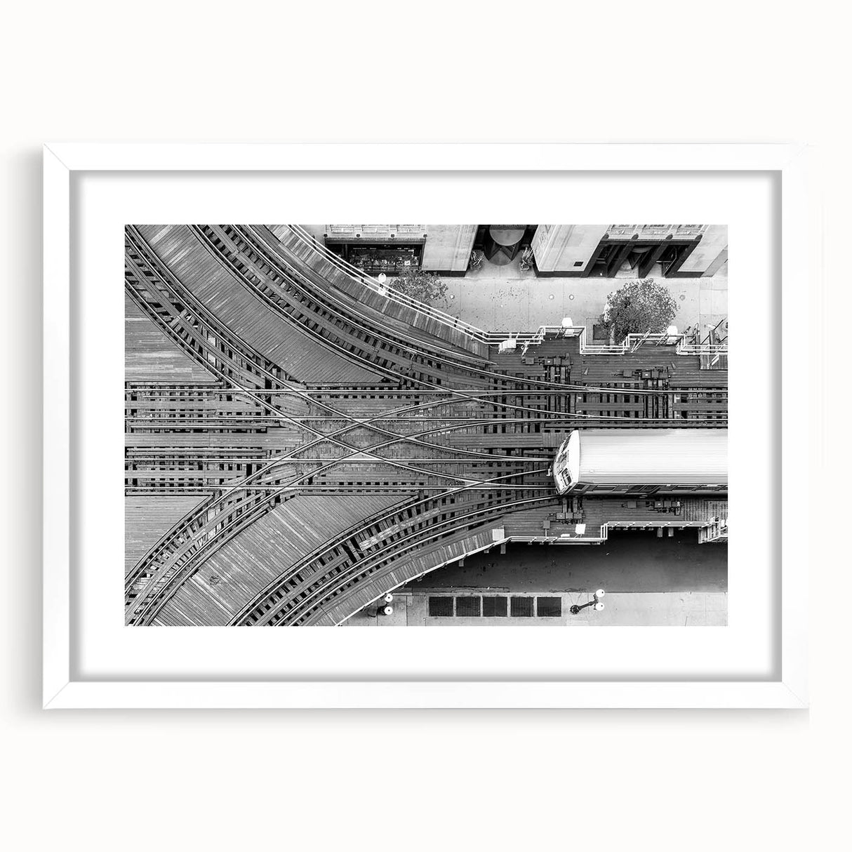 Abstract art print of the Chicago skyline, featuring muted gray and blue tones on a framed white mat.