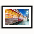 Colorful abstract art print of a textured New Orleans scenery in a large black frame, ideal for living room decor.