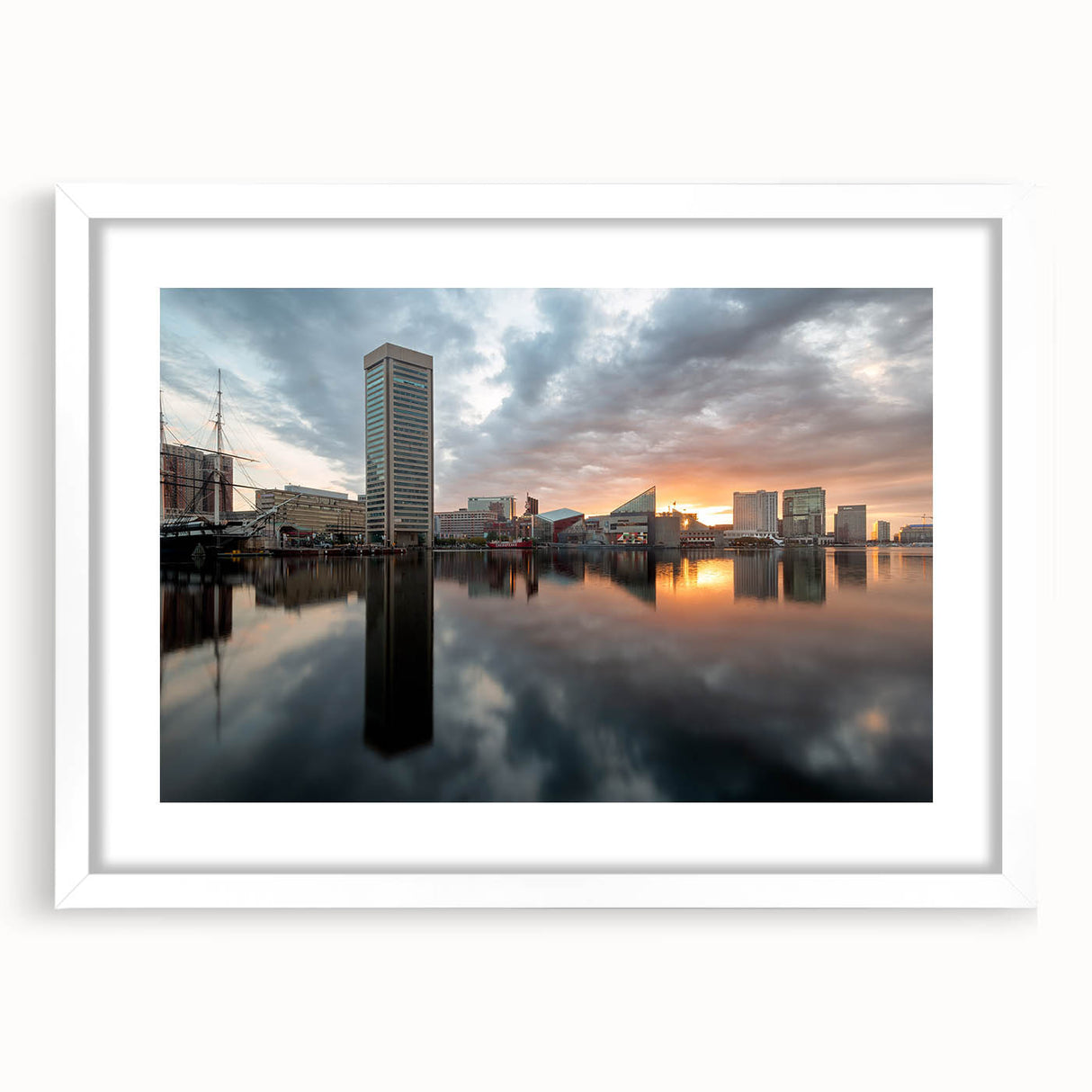 Abstract art print of Baltimore skyline in muted gray and blue tones on a framed white mat, suitable for dining room decor.