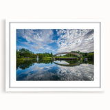 Abstract art print of Charlotte skyline in muted blue and gray tones on a framed white mat, ideal for dining room decor.
