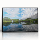 Large abstract wall art of Charlotte skyline in muted blues and grays, framed in black acrylic.