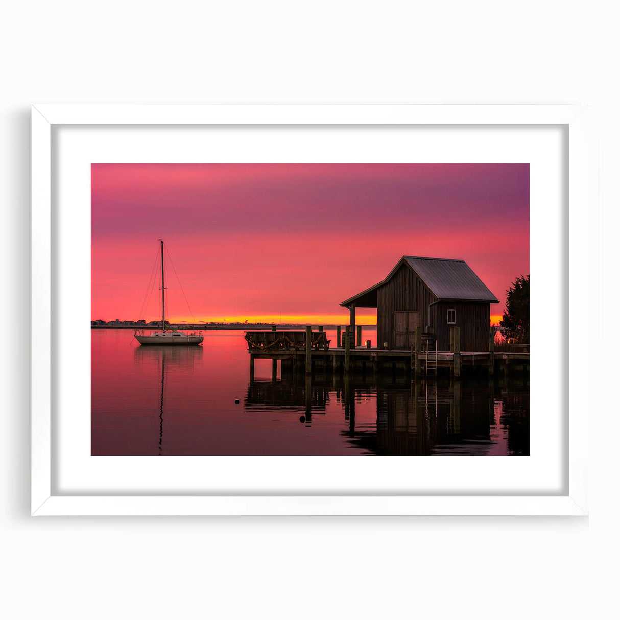 Abstract art print of the Outer Banks in muted blue and gray tones on a framed white mat, ideal for dining room decor.