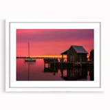 Abstract art print of the Outer Banks in muted blue and gray tones on a framed white mat, ideal for dining room decor.