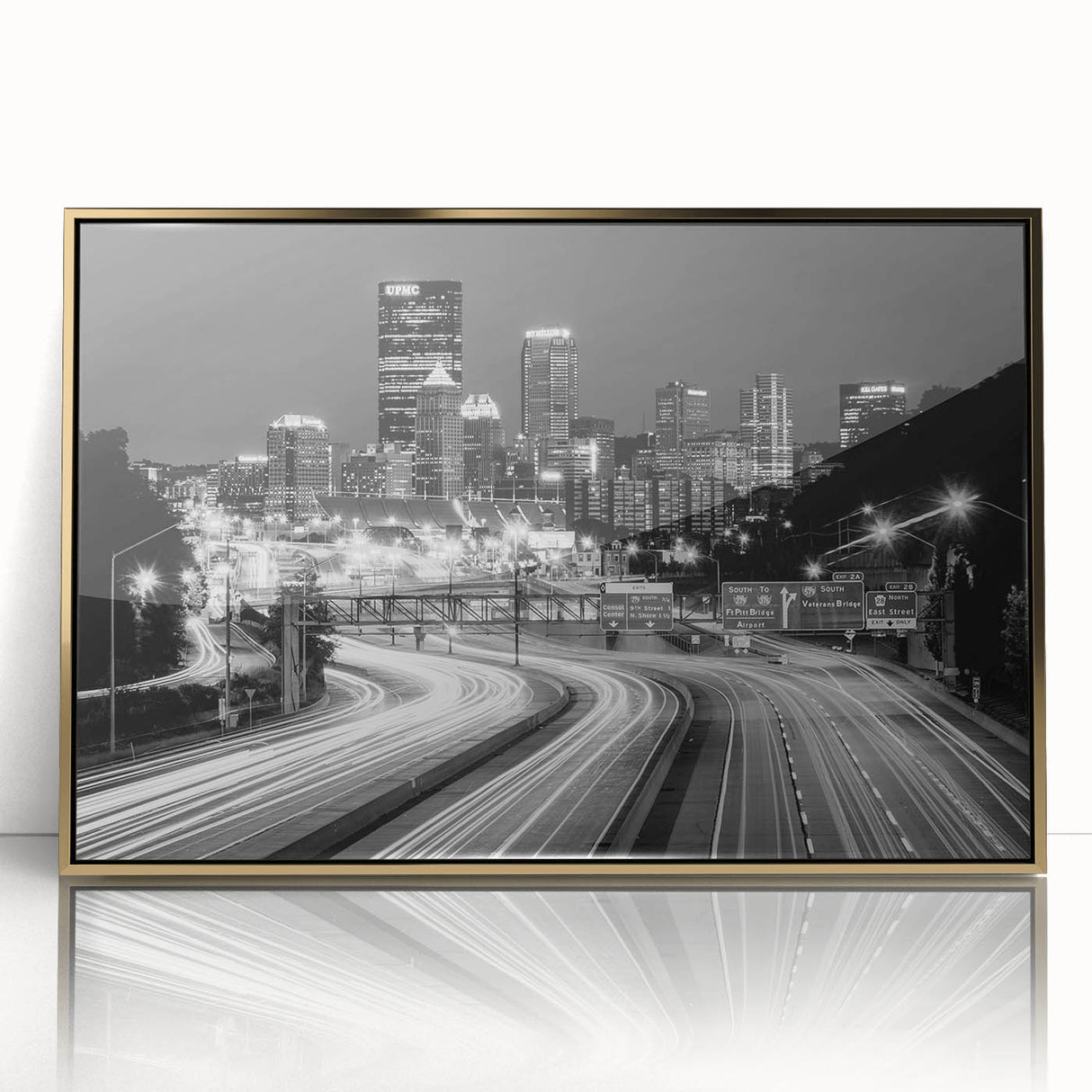 Acrylic print of Pittsburgh skyline in gold and blue tones, framed, ideal for modern art wall decor.