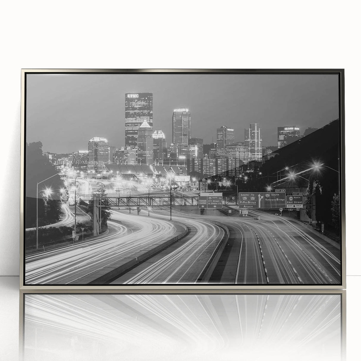 Mid-century modernist art of Pittsburgh skyline in muted metallic tones on a framed acrylic print.
