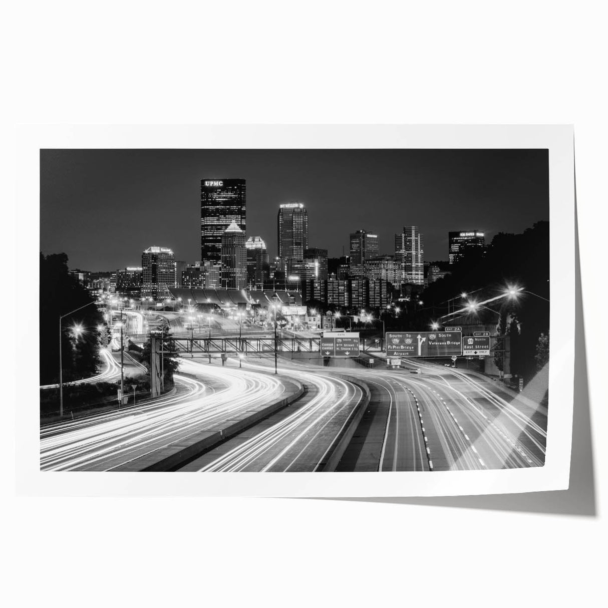 Rolled print of Pittsburgh skyline with floral elements in muted earth tones, suitable for dining room or bathroom wall art.