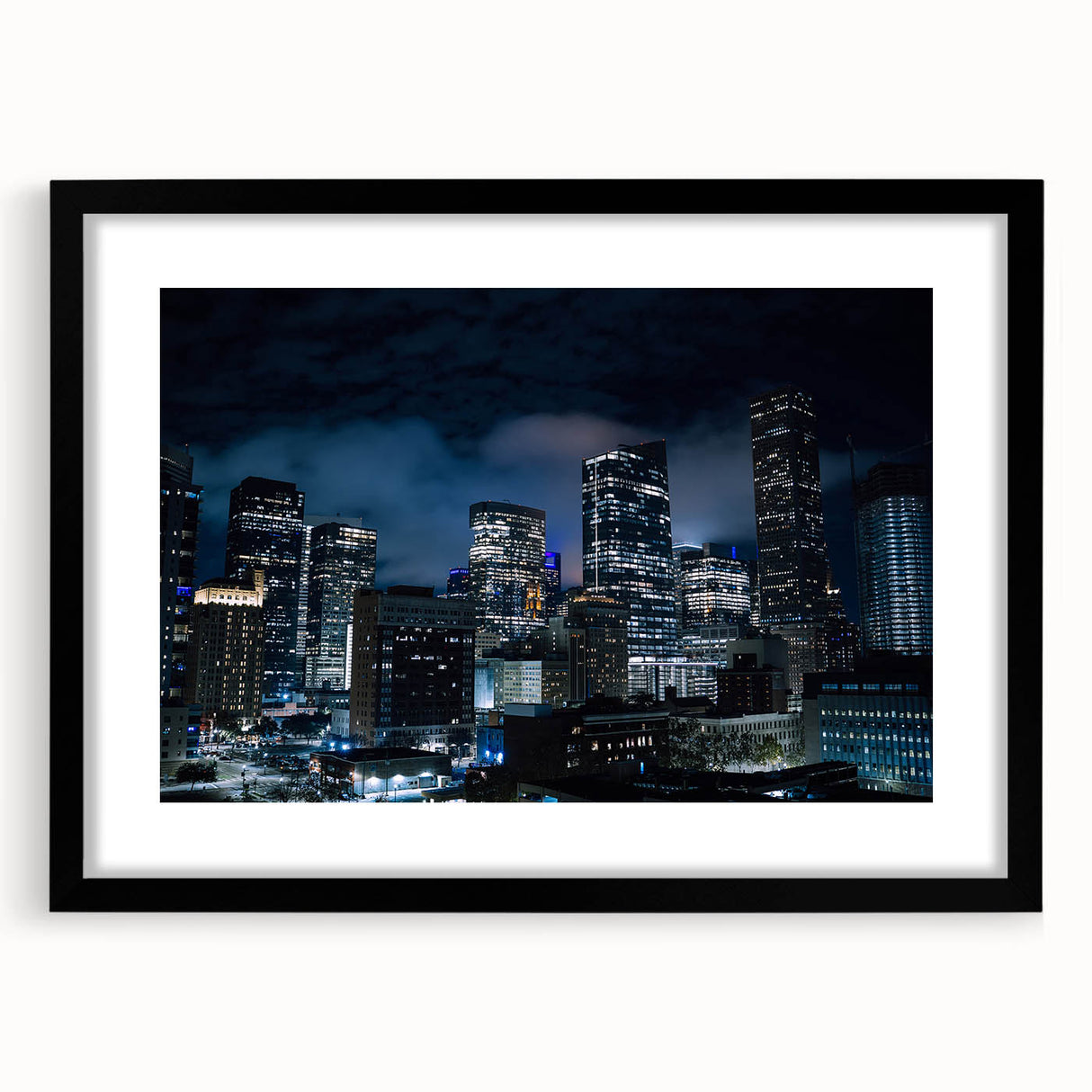 Extra large abstract art print of Houston skyline featuring vibrant, colorful textures on a framed black mat.