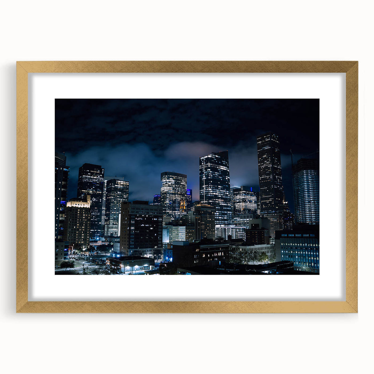 Extra large abstract art print of Houston skyline in muted gray and gold tones, framed with a gold mat.