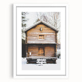 Abstract art print depicting a winter scene in muted blue and white tones, framed with a white mat.