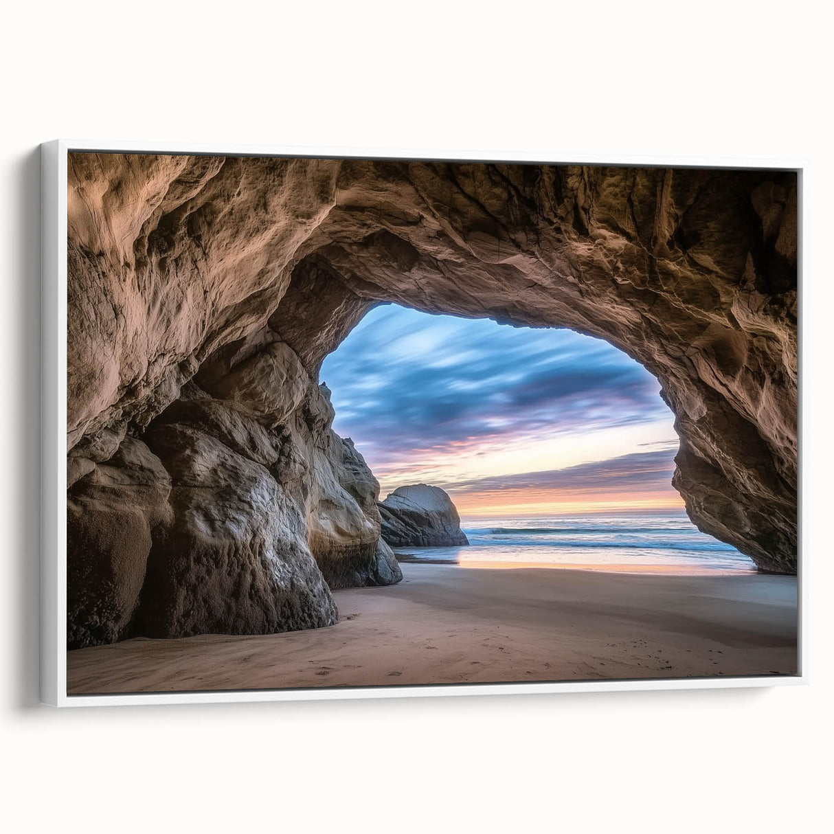 Framed canvas artwork showcasing a stunning landscape with cave formations, presented in a sleek white frame, ideal for enhancing modern interior decor.
