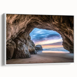 Framed canvas artwork showcasing a stunning landscape with cave formations, presented in a sleek white frame, ideal for enhancing modern interior decor.