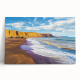 Stretched canvas artwork depicting dramatic cliffs and landscapes in earthy tones, elegantly leaning against a wall, perfect for enhancing modern home decor.