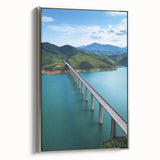 Framed canvas artwork showcasing a detailed landscape bridge design, featuring a silver frame and vibrant colors, ideal for home decor or art enthusiasts.