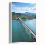 Framed canvas artwork depicting a serene landscape bridge viewed from the side, featuring a mix of earthy tones and lush greenery, ideal for home decor.