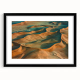 Framed landscape artwork depicting a serene desert scene, featuring warm earthy tones and a matte black frame, perfect for modern home decor.