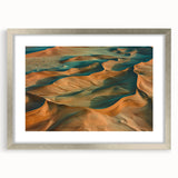 Silver-framed desert landscape artwork with a white mat, showcasing intricate details and vibrant colors, ideal for enhancing modern home decor.
