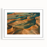 Desert landscape framed artwork showcasing vibrant hues of orange and yellow, with a white mat and sleek frame, perfect for modern home decor.