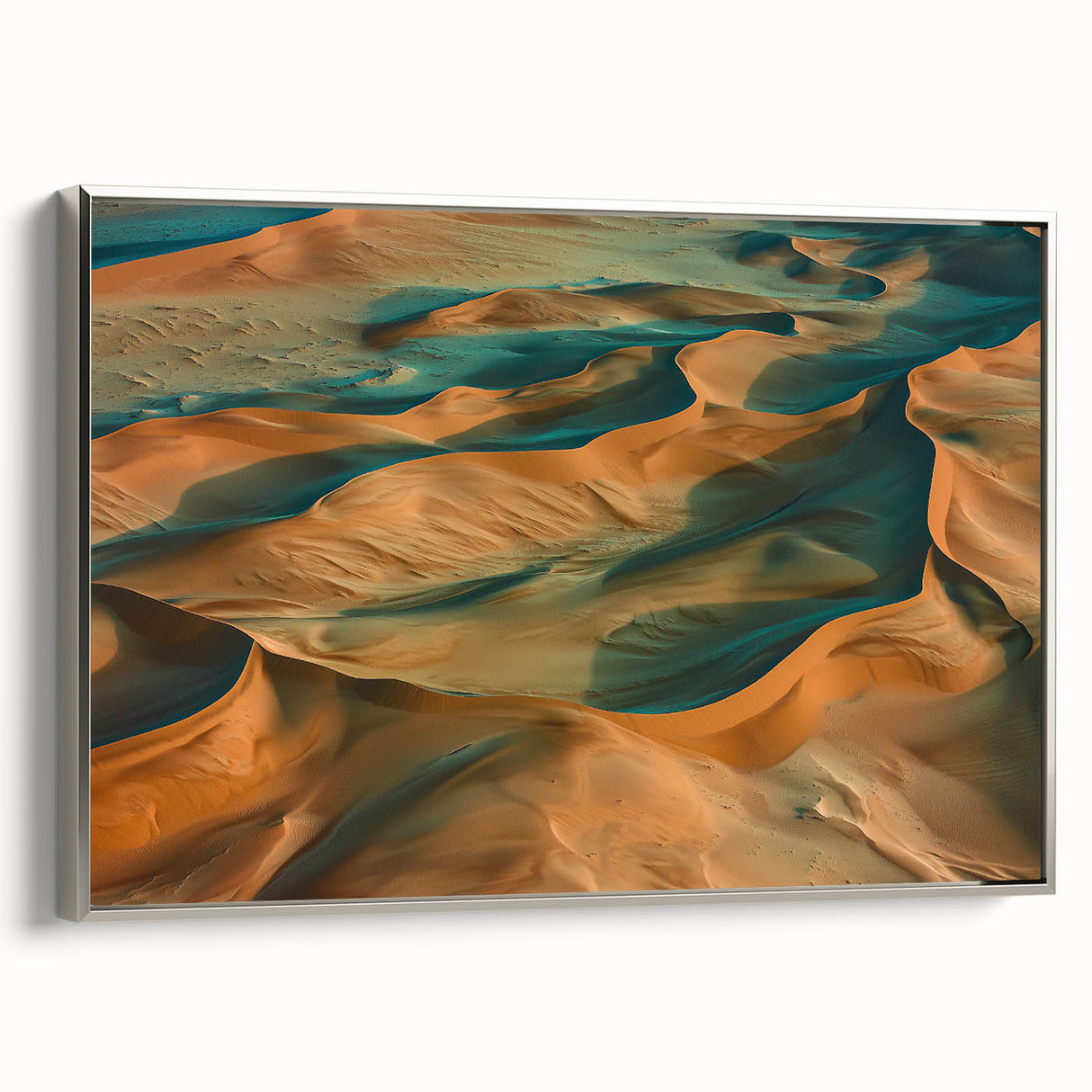 Framed canvas artwork showcasing a serene desert landscape, featuring soft sandy hues and intricate details, elegantly bordered with a silver frame for a modern touch.
