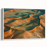 Framed canvas artwork showcasing a vibrant desert landscape with warm hues of orange and yellow, elegantly displayed from a white side view, perfect for home decor.
