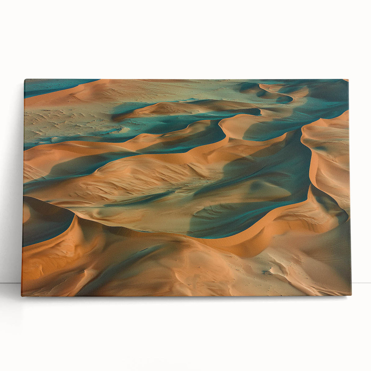 Stretched canvas artwork showcasing a vibrant desert landscape with warm hues of orange and yellow, leaning against a neutral wall, ideal for home decor.