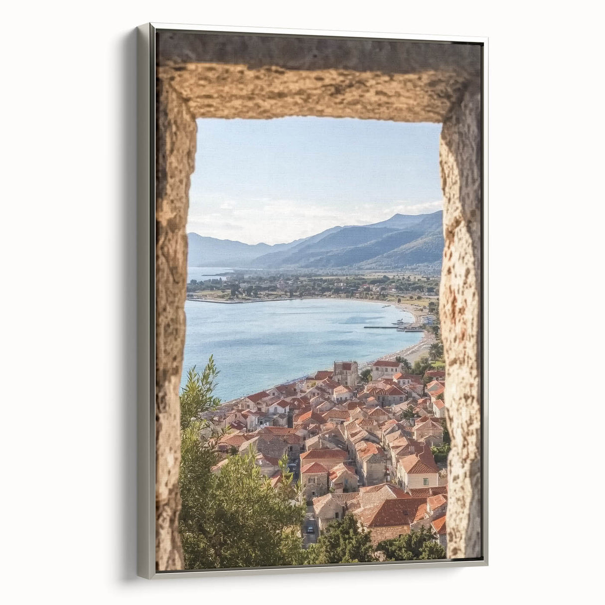 Framed canvas artwork depicting a serene landscape with a majestic castle, featuring ornate silver framing and a side view showcasing its elegant design. Ideal for home decor enthusiasts seeking a touch of sophistication and charm in their interior spaces.