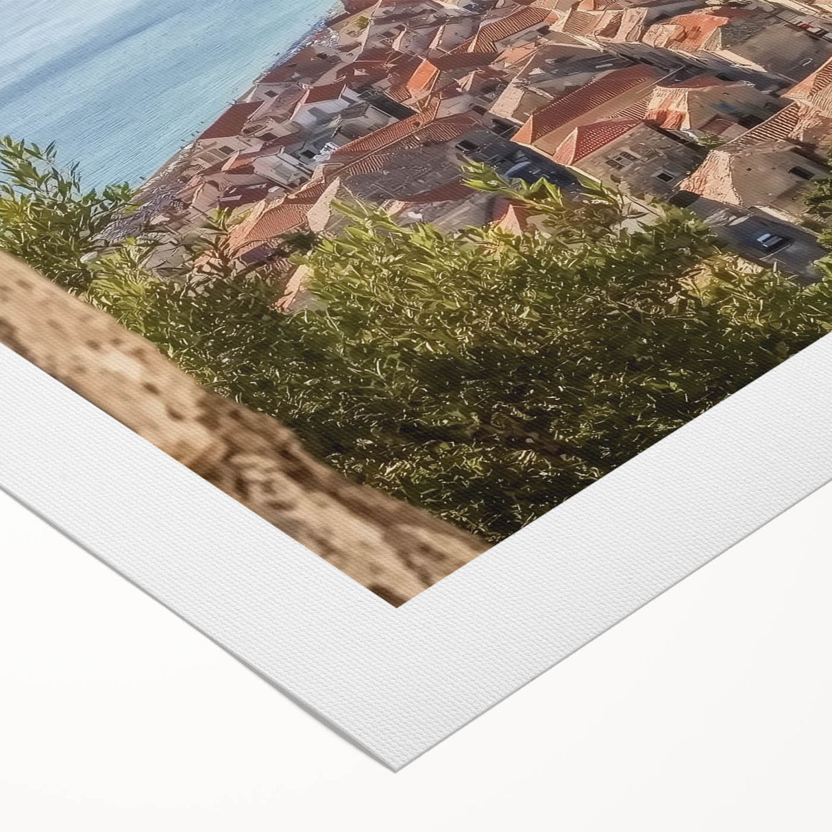 Rolled canvas print showcasing a stunning landscape featuring a majestic castle surrounded by lush greenery and a vibrant blue sky, elegantly packaged in a protective cardboard tube for safe delivery.