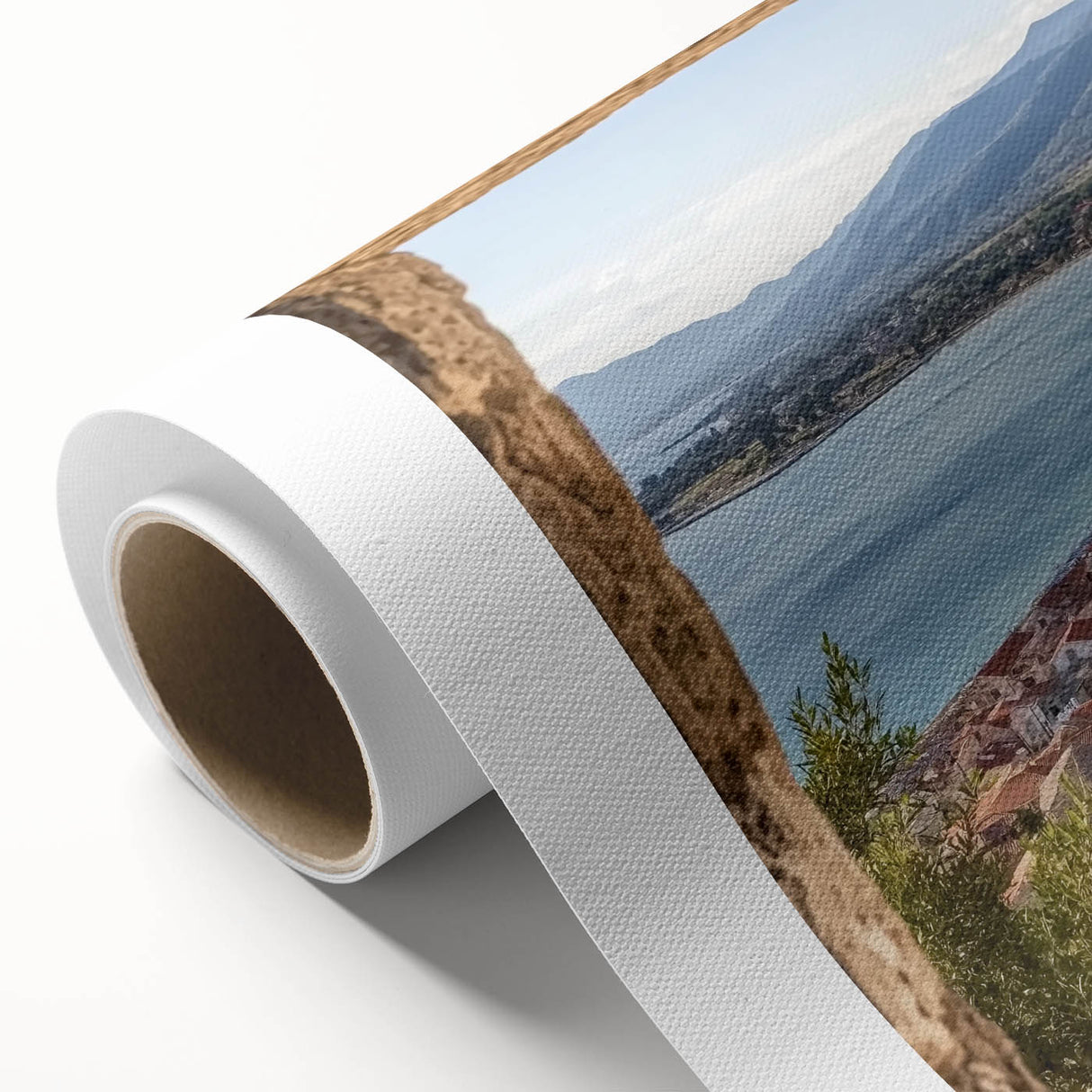 Rolled canvas artwork showcasing a vibrant landscape featuring a majestic castle surrounded by lush greenery and mountains, elegantly packaged in a protective cardboard tube.