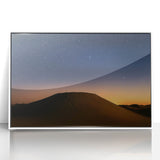 Framed acrylic artwork depicting a vibrant desert landscape with warm tones of orange and yellow, set against a crisp white background, ideal for home decor.