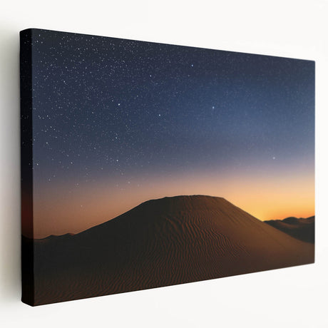Stretched canvas artwork depicting a vibrant desert landscape with rich orange and brown tones, showcasing rolling dunes under a bright blue sky, ideal for home decor.