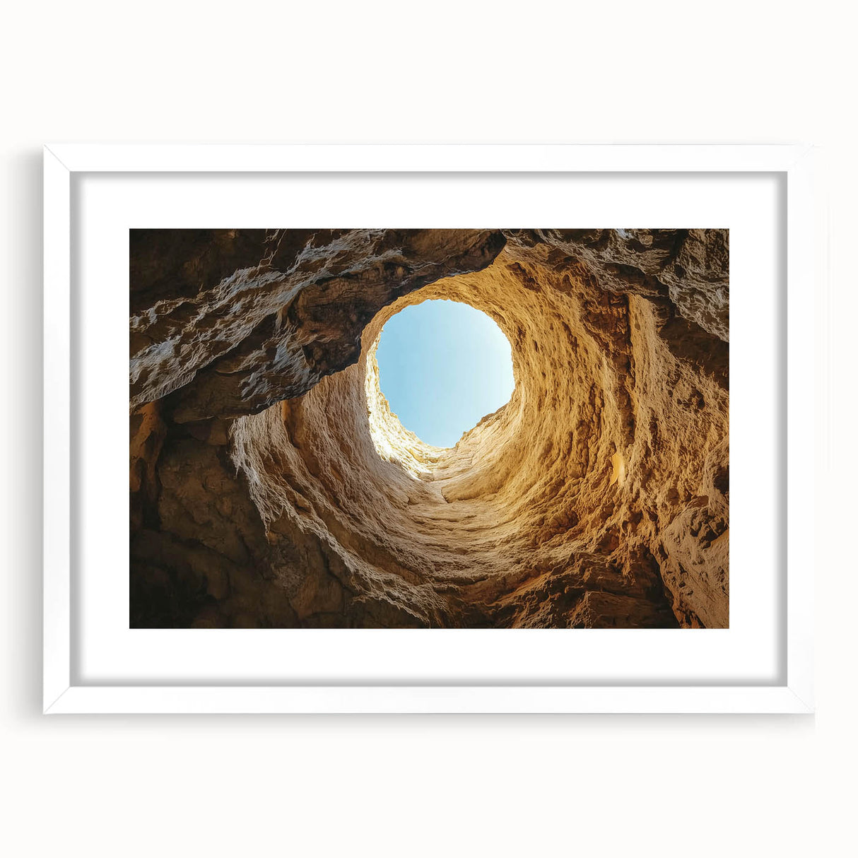 Framed landscape artwork depicting a serene cave scene with neutral tones and a white mat, showcasing intricate details, perfect for home decor.