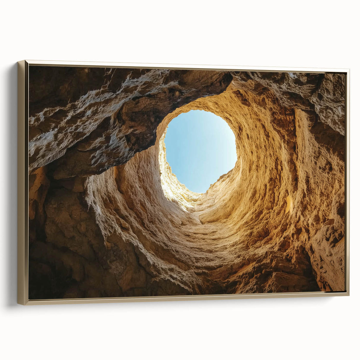 Framed canvas art depicting a stunning landscape scene featuring caves, accented with a luxurious gold frame, ideal for enhancing home decor with a touch of elegance.
