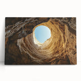 Stretched canvas artwork depicting a serene landscape with dramatic caves and vibrant colors, ideal for home decor or office settings, showcasing nature's beauty.