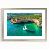 Framed landscape artwork showcasing dramatic cliffs under a blue sky, accented with a silver mat and frame, ideal for enhancing modern home decor.