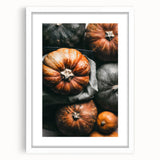 Abstract art print featuring autumnal hues on a white framed canvas, ideal for dining room decor.